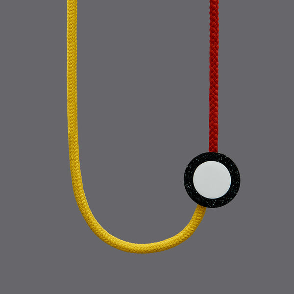The Beck necklace is a Bright and striking statement necklace inspired by the London Underground Tube Map. Bright yellow and red rope work in combination with resin parts. Full drop 40cm, fully adjustable using a black ball which sits behind the neck. 
