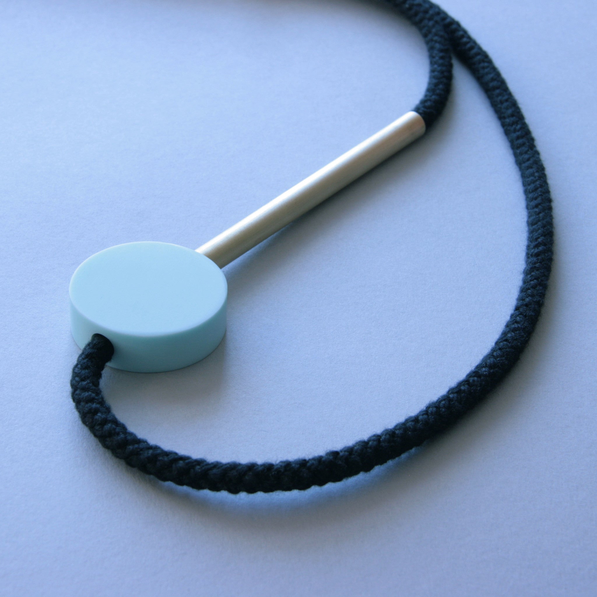 The Gia necklace is a pared down and striking design. Composed of a perfect mint resin circle and a 10cm brass tube. Cord length is fully adjustable using the little wooden ball at the back of the neck. This necklace can work both on a casual outfit or in a smarter look too. Handmade in our London studio. 