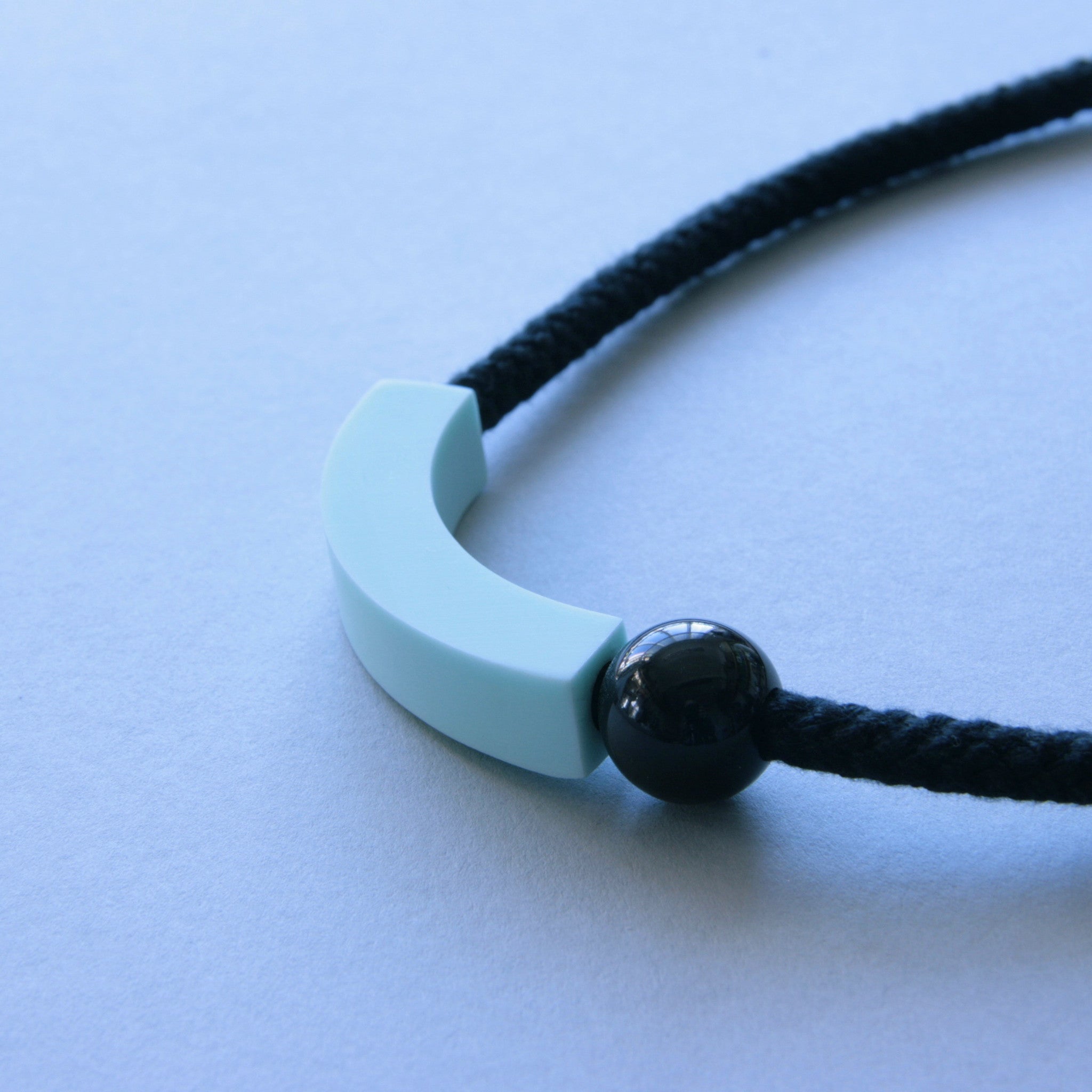 The Arp necklace is minimalist and striking. The mint resin curve sits off-centre beside a small black resin ball, offering a simple, but interesting design. The necklace is quite light, so very wearable. A contemporary design. Comes boxed in our branded kraft tube.
