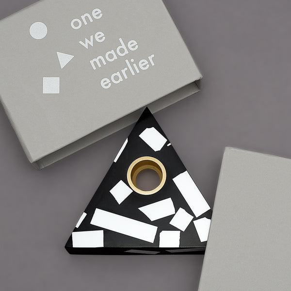 Each candle holder is hand made from black Jesmonite with graphic white chips. It has a fixed brass insert. Designs come packaged within a branded box. Subtle variations of white chip arrangement makes each piece unique. Product dimensions: 11cm x 11cm x 3cm Candle not included.