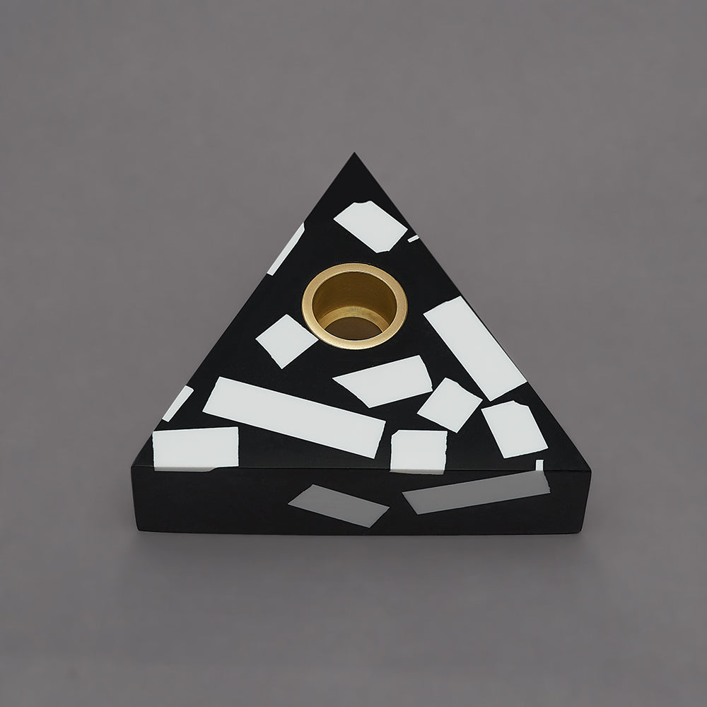 Each candle holder is hand made from black Jesmonite with graphic white chips. It has a fixed brass insert. Designs come packaged within a branded box. Subtle variations of white chip arrangement makes each piece unique. Product dimensions: 11cm x 11cm x 3cm Candle not included.
