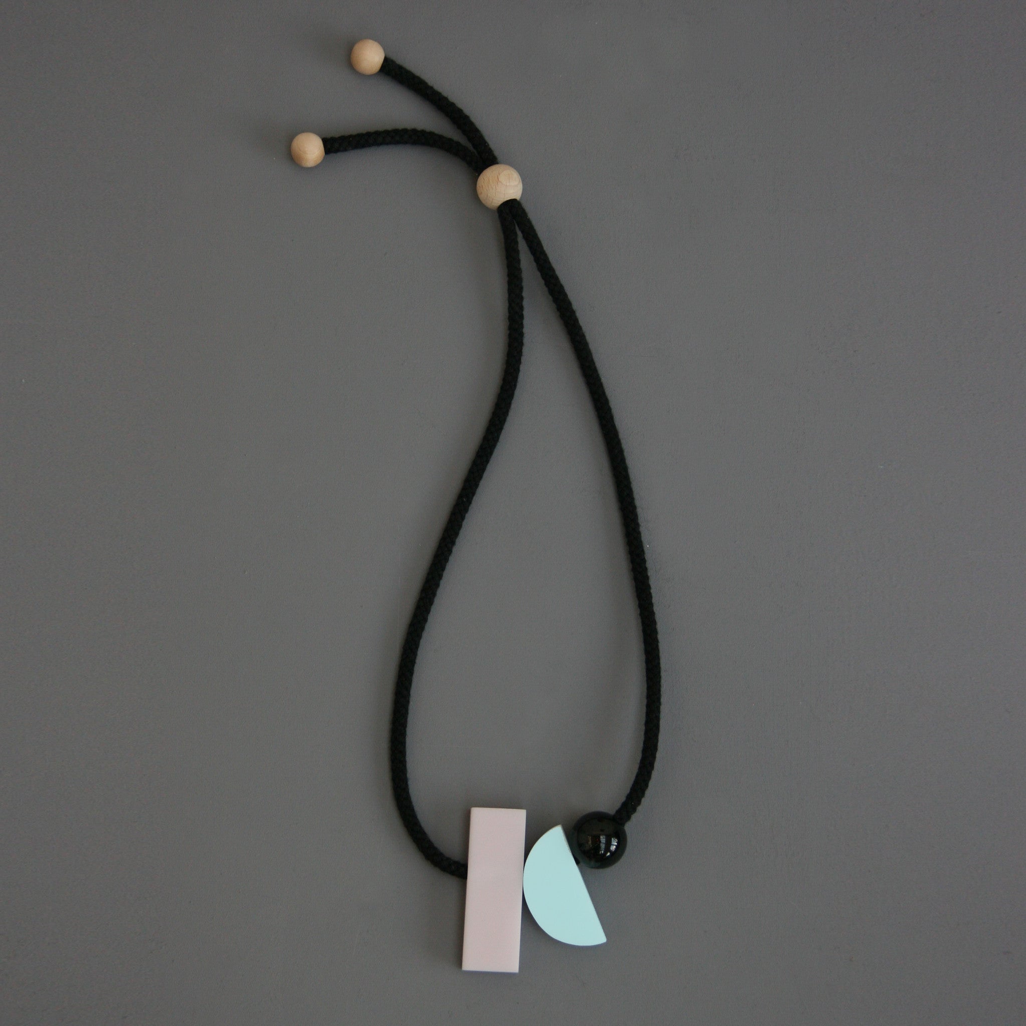 Dora is a fresh minimal and stylish necklace. The pastel colours and geometric shapes look great against a simple top. It hangs really nicely. Dora is composed of 3 parts. A pink rectangular resin section (70mm x 23mm), a pale blue resin curve (50mm x 23mm) and a small black resin ball (25mm). 
