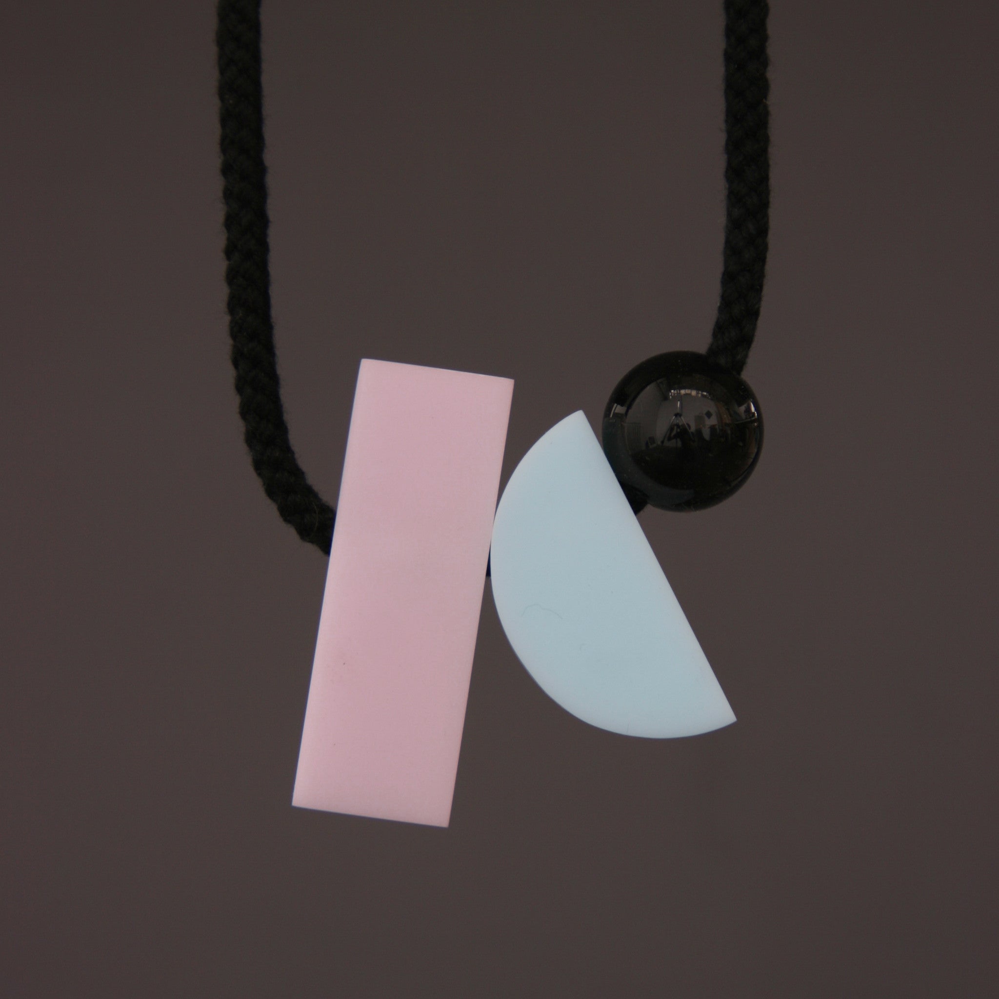 Dora is a fresh minimal and stylish necklace. The pastel colours and geometric shapes look great against a simple top. It hangs really nicely. Dora is composed of 3 parts. A pink rectangular resin section (70mm x 23mm), a pale blue resin curve (50mm x 23mm) and a small black resin ball (25mm). 
