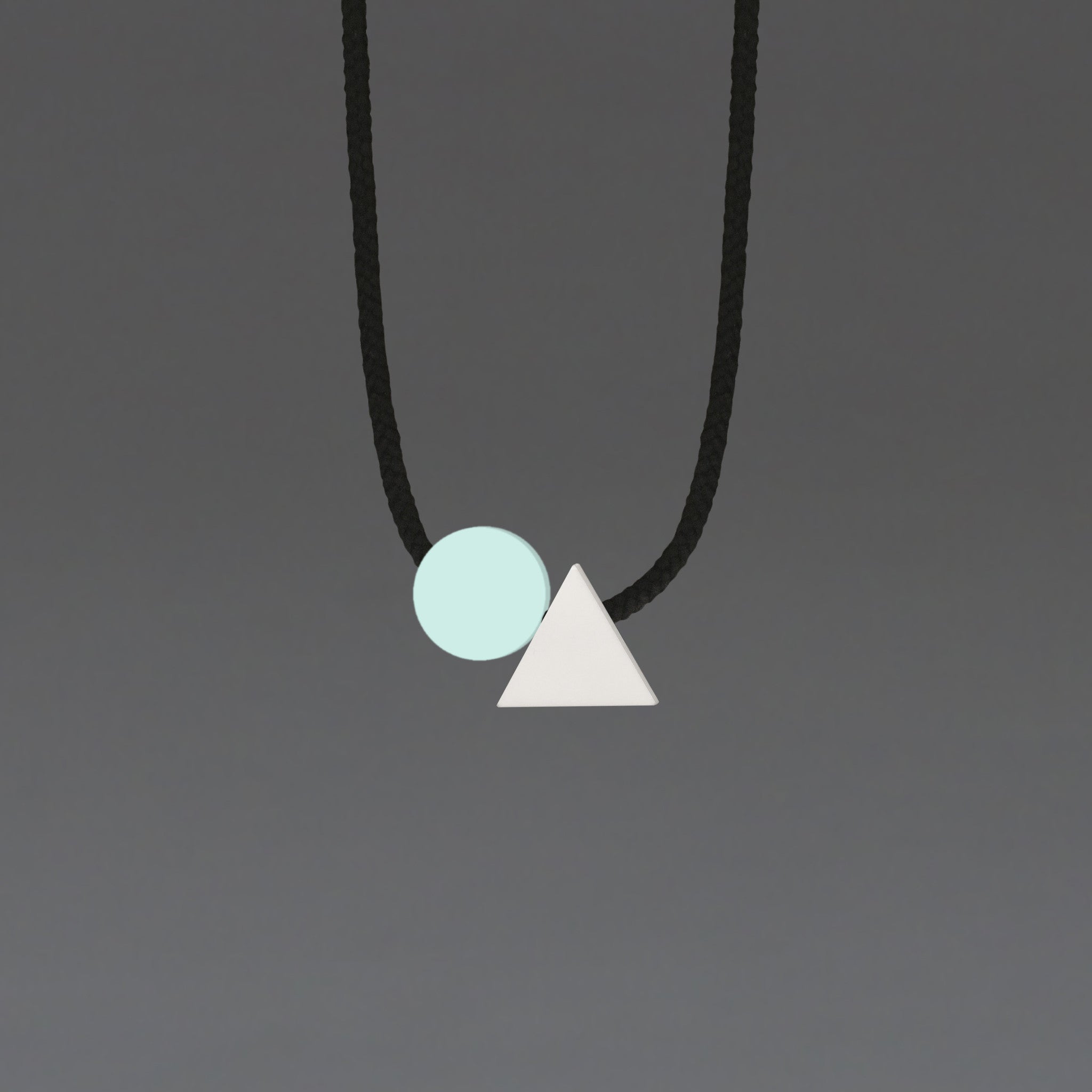 The Ellsworth necklace is a pleasing balance of 2 geometric shapes. A mint circle sits neatly beside a white triangle offering a striking and minimal addition to any outfit. A geometric statement necklace.
