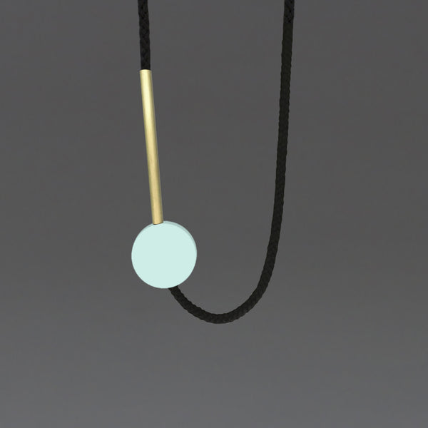The Gia necklace is a pared down and striking design. Composed of a perfect mint resin circle and a 10cm brass tube. Cord length is fully adjustable using the little wooden ball at the back of the neck. This necklace can work both on a casual outfit or in a smarter look too. Handmade in our London studio. 