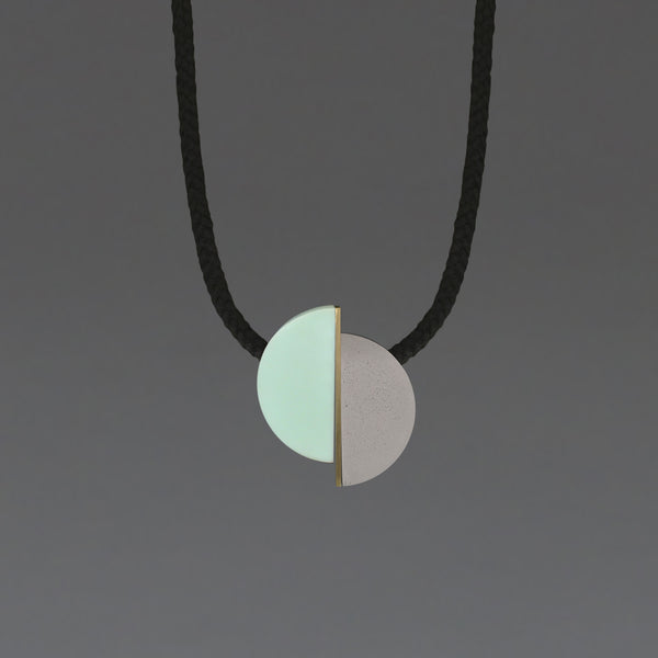 The Klee necklace is both elegant and fun. The three sections can move freely allowing the design to fall in different ways.  Klee is composed of our hand cast concrete-resin, a brass strip and a mint resin curve. A playful, contemporary design.