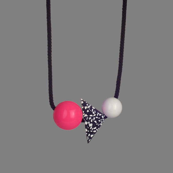 The Lina necklace is a statement necklace - bold and striking. It is composed of 3 parts - a bright pink resin ball (38mm), a triangle of black resin with white chips (70mm x 50mm) and a white resin ball (30mm). Black cord full drop 45cm. 