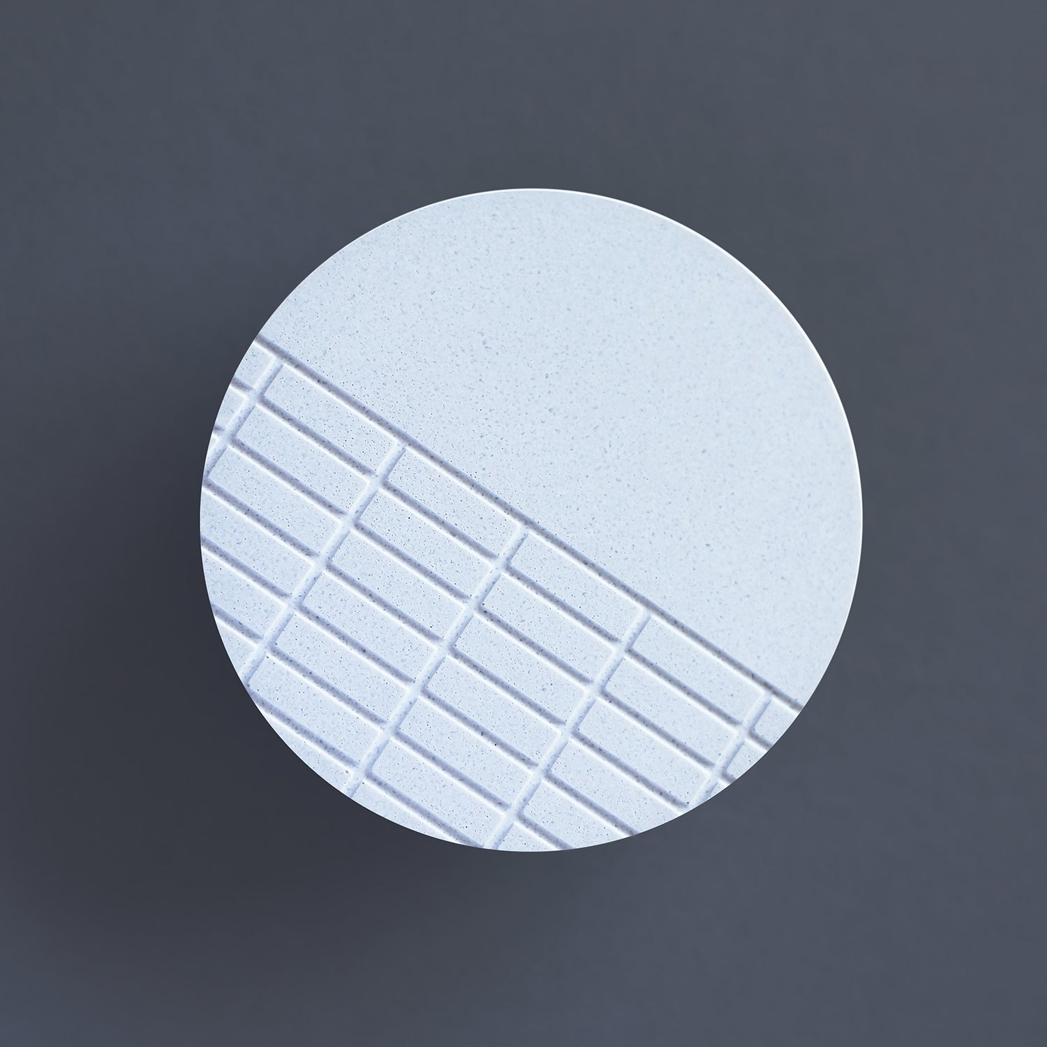 Handcast brooch inspired by the brutalist architecture of London's Barbican centre. This circular brooch has a fine grid recessed over half of the surface. Each brooch is cast by hand in our south London studio and comes in branded gift box. (7cm diameter) 