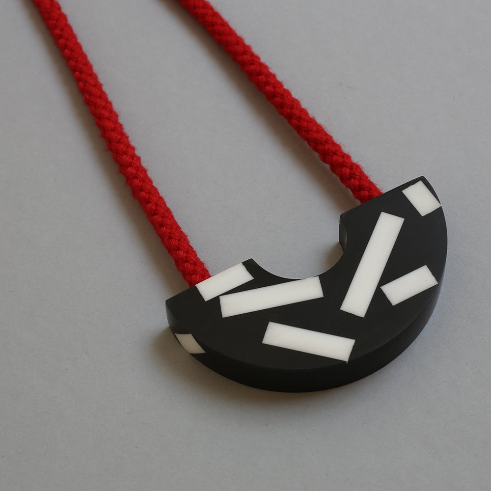 Say hello to our new Ito necklace! This handcast necklace is available with a yellow, red or blue cord. The black speckled curve is cast by hand in our studio using jesmonite meaning that each necklace is unique. The speckles are bold and white creating a striking design. 