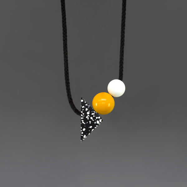 Otto is a statement necklace by London design brand One We Made Earlier. Hnad cast Jesmonite triangle and bright resin balls. Modern design, geometric shapes.